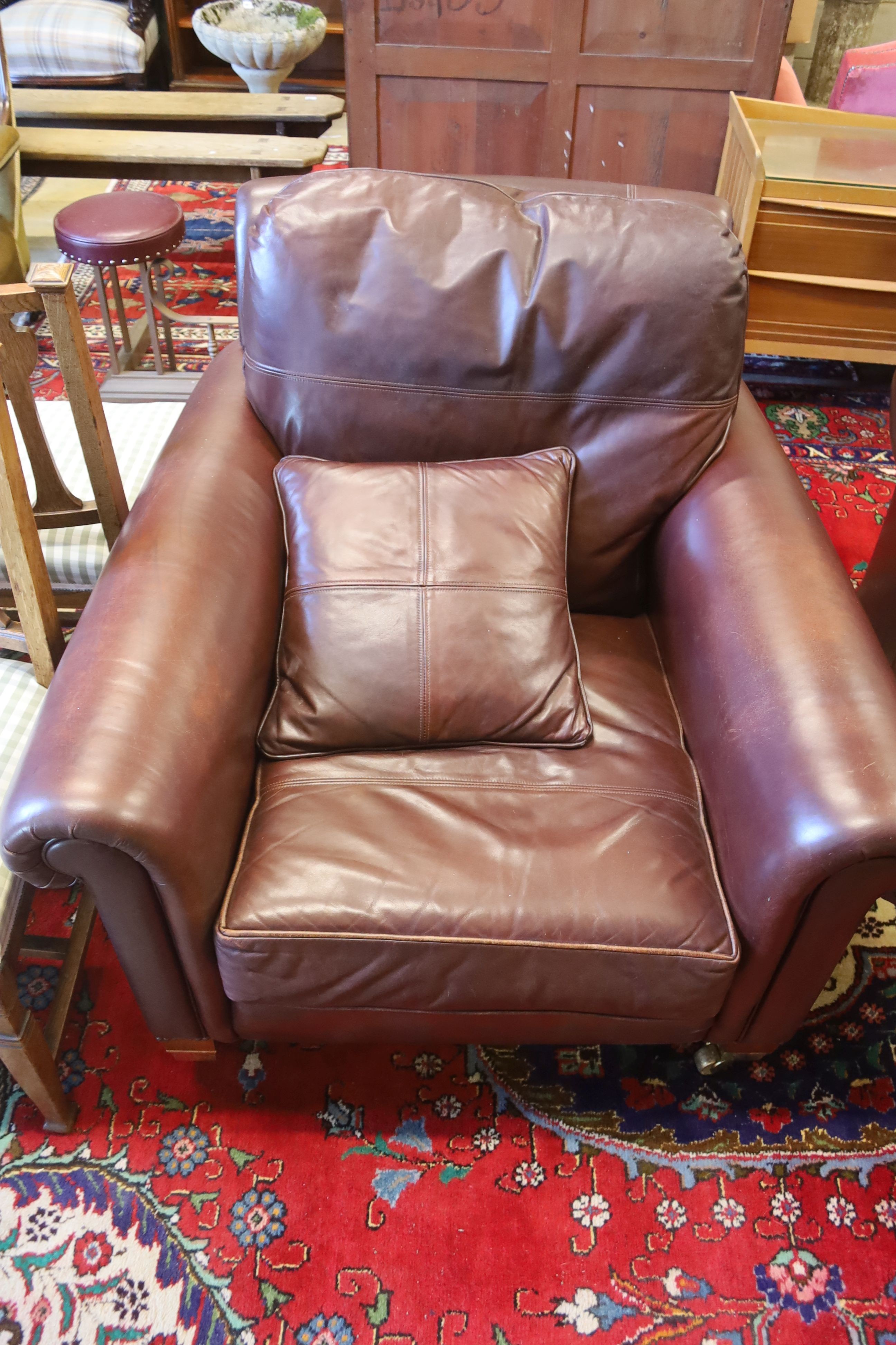 A Duresta brown leather settee and matching armchair, settee length 210cm, depth 102cm, height 90cm